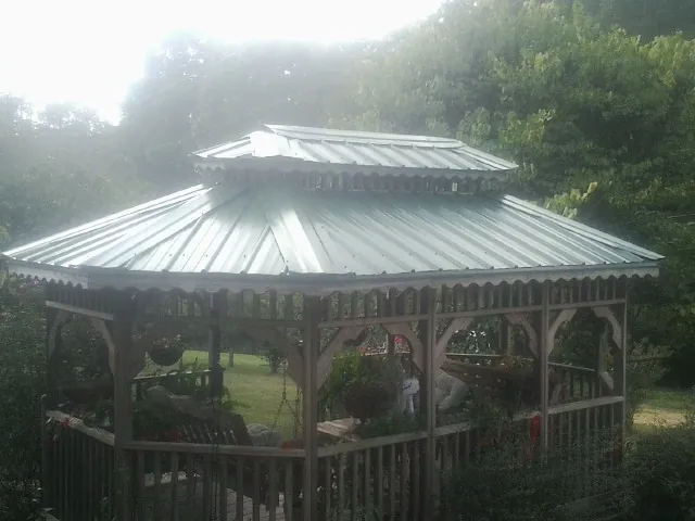 Two tier green metal roof on a garden gazebo in Somers